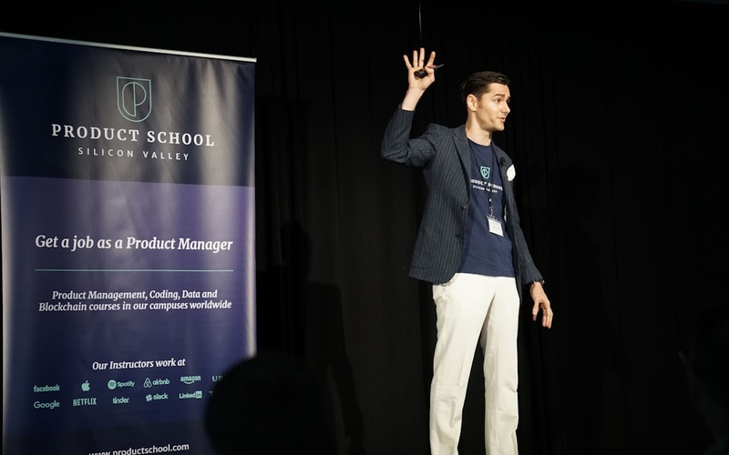 Young entrepreneur presenting startup pitch with blockchain technology and funding metrics displayed